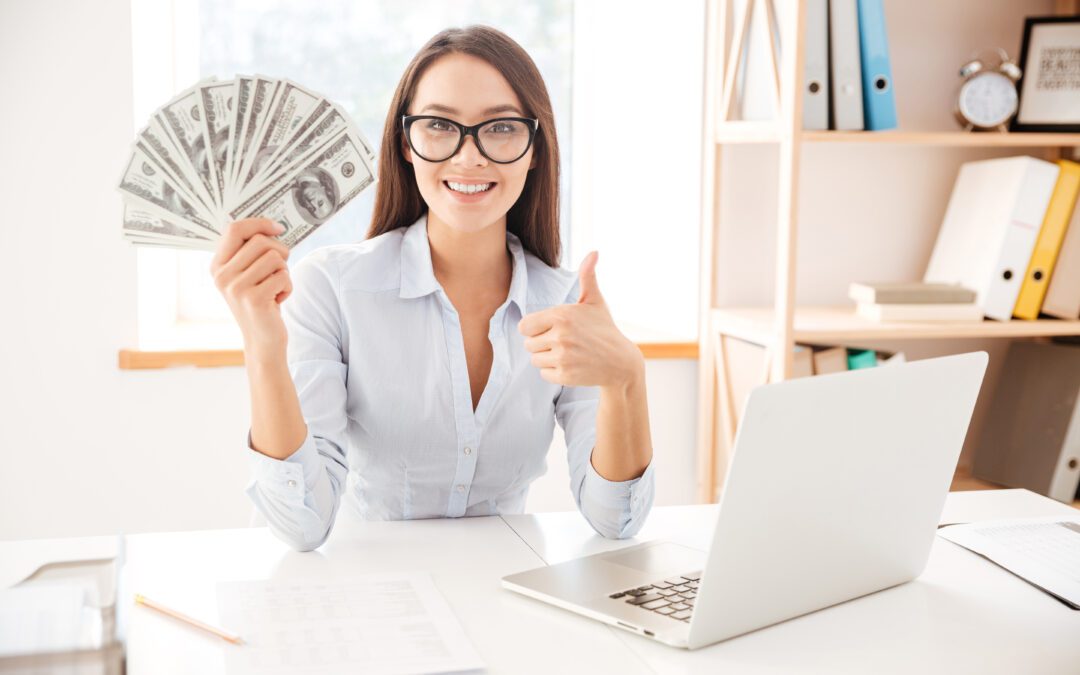 Businesswoman Holding Money While Making Thumbs Up Gesture